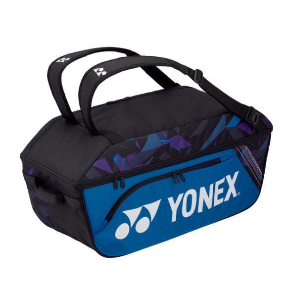 The Yonex 92214EX Pro Wide Open Racket Bag in fine blue, by Yonex, provides ample space with its roomy main compartment perfect for rackets. It includes two carrying handles, a zippered front pocket, and prominently showcases the iconic Yonex logo.