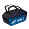 The Yonex 92214EX Pro Wide Open Racket Bag in fine blue, by Yonex, provides ample space with its roomy main compartment perfect for rackets. It includes two carrying handles, a zippered front pocket, and prominently showcases the iconic Yonex logo.