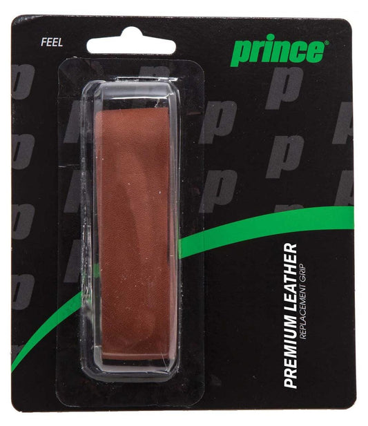 The Prince Premium Leather Replacement Tennis Grip is presented in packaging that features calfskin leather within a transparent plastic covering, set against a black and green card. The words "FEEL" and "ULTIMATE RACKET FEEL" emphasize its high-quality craftsmanship.