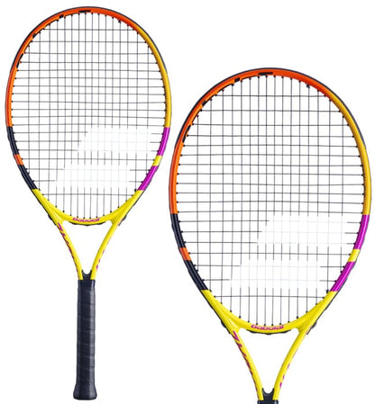 A pair of Babolat Nadal Junior 26 Tennis Rackets, showcasing vivid colors with yellow, orange, and purple accents. One racket is depicted in a side profile while the other one faces forward, highlighting its strings and grip, both carrying a sleek and modern design from the Babolat brand.